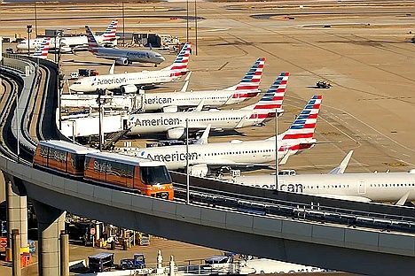 American Airlines fleet at DFW Airport with Skylink train – premium chauffeur pickup and private SUV transfer service in Dallas.