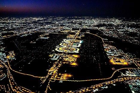 Exclusive DFW Airport private chauffeur services – illuminated terminal circles from above, connecting luxury SUV arrivals and transfers.