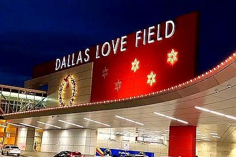 Travelers inside Dallas Love Field Airport terminal passing through TSA security, with exclusive black car and chauffeur services available