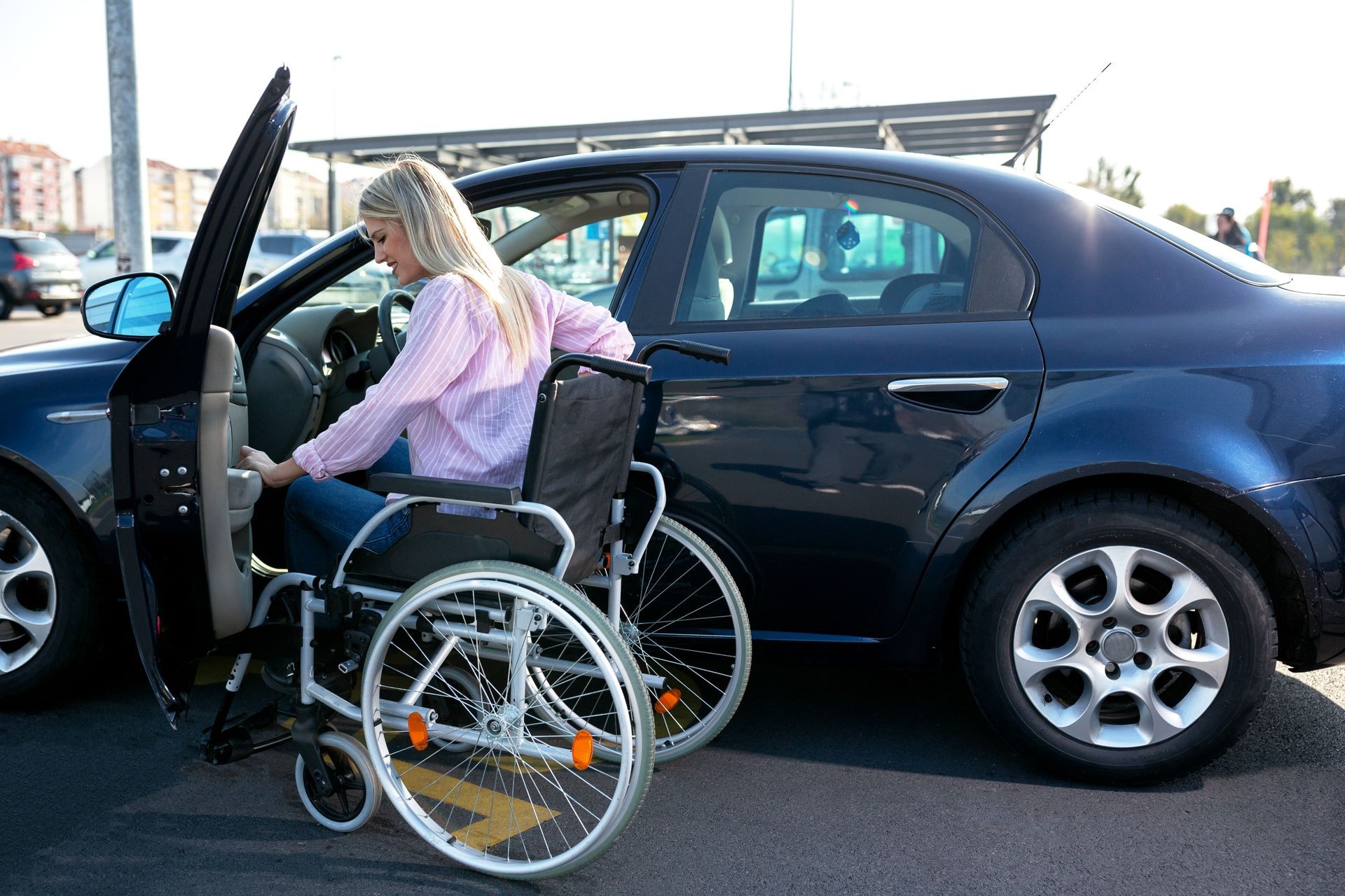 Image of young disabled woman trying to reach her car on the parking lot Image of young disabled woman trying to reach her car on the parking lot